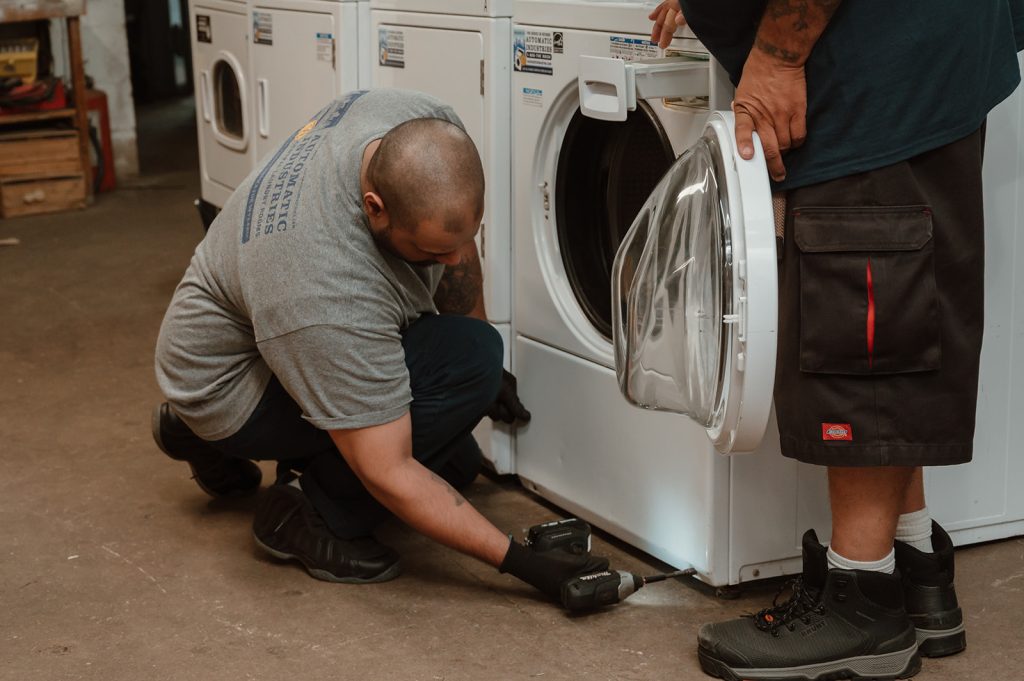 Couple doing laundry together at laundromat